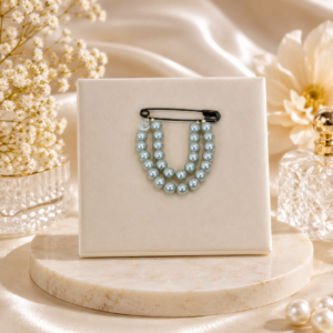 Steel grey pearl brooch with elegant floral pattern, ideal for sarees, blazers, coats, and formal occasions.