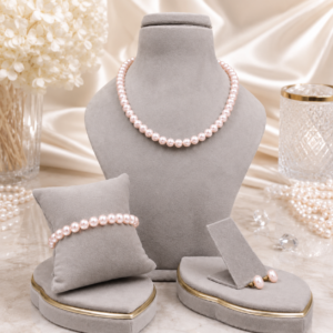 Rose pink pearl necklace set featuring matching bracelet and earrings with elegant handcrafted detailing.
