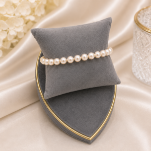 Cream pearl bracelet with smooth round pearls arranged in a timeless beaded bracelet design.