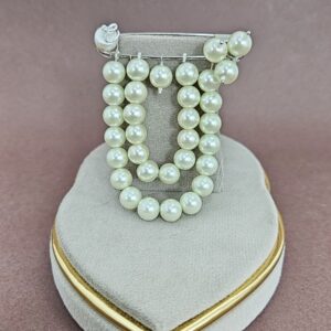 Layered pearl cascade brooch with multi-strand design