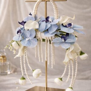 Luxury pearl cascade bouquet with blue orchid florals and flowing pearl strands displayed on a gold stand by EVAARAZ