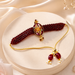 Handmade peacock designer rakhi featuring green crystal beads, colorful artwork and kundan stone embellishments.