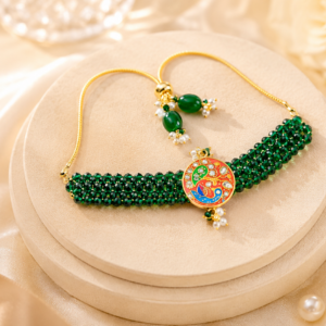 Handmade green floral rakhi featuring kundan stones, pearl beadwork and traditional Indian craftsmanship